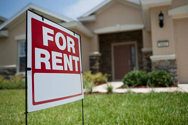 Real estate agent showing a modern home interior to prospective tenants